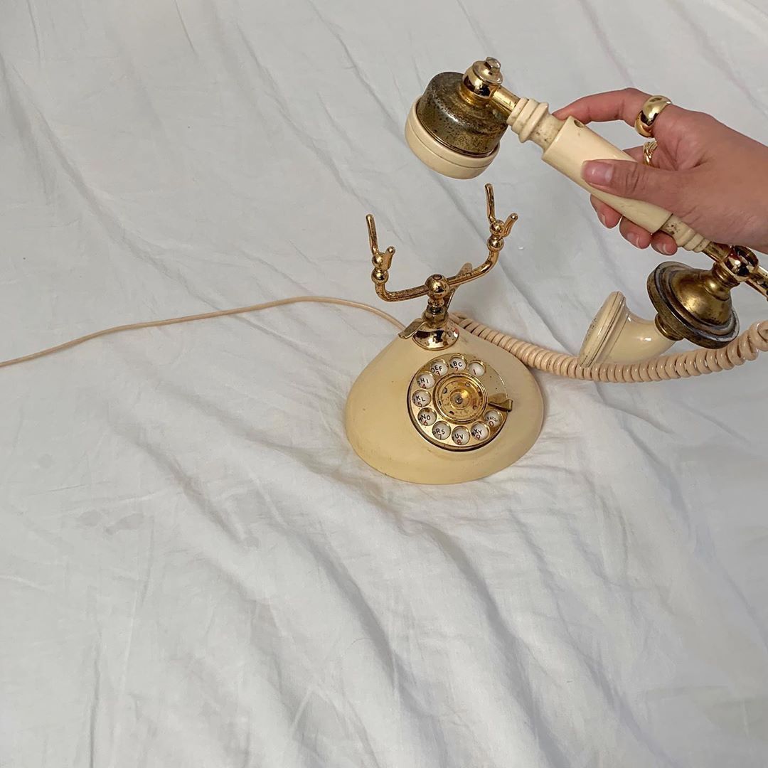 Hand hanging up a phone as a ritual of digital detox and unplugging