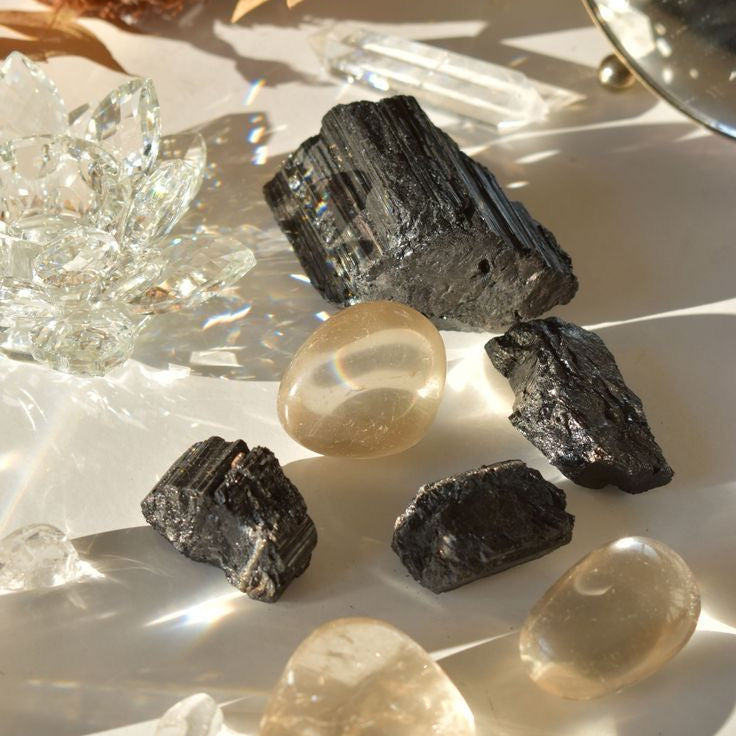 Collection of protection crystals including Black Tourmaline, Amethyst, Smoky Quartz, Obsidian, Labradorite, and Clear Quartz
