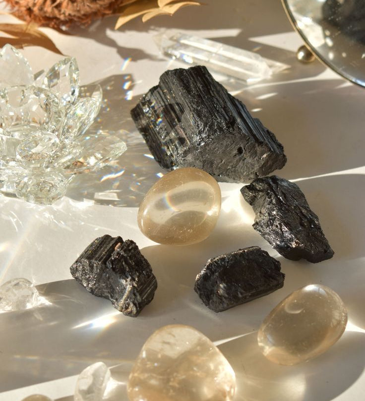 Collection of protection crystals including Black Tourmaline, Amethyst, Smoky Quartz, Obsidian, Labradorite, and Clear Quartz