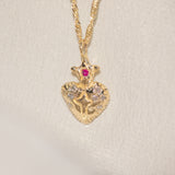 Gold pendant necklace with a heart design on a beige background